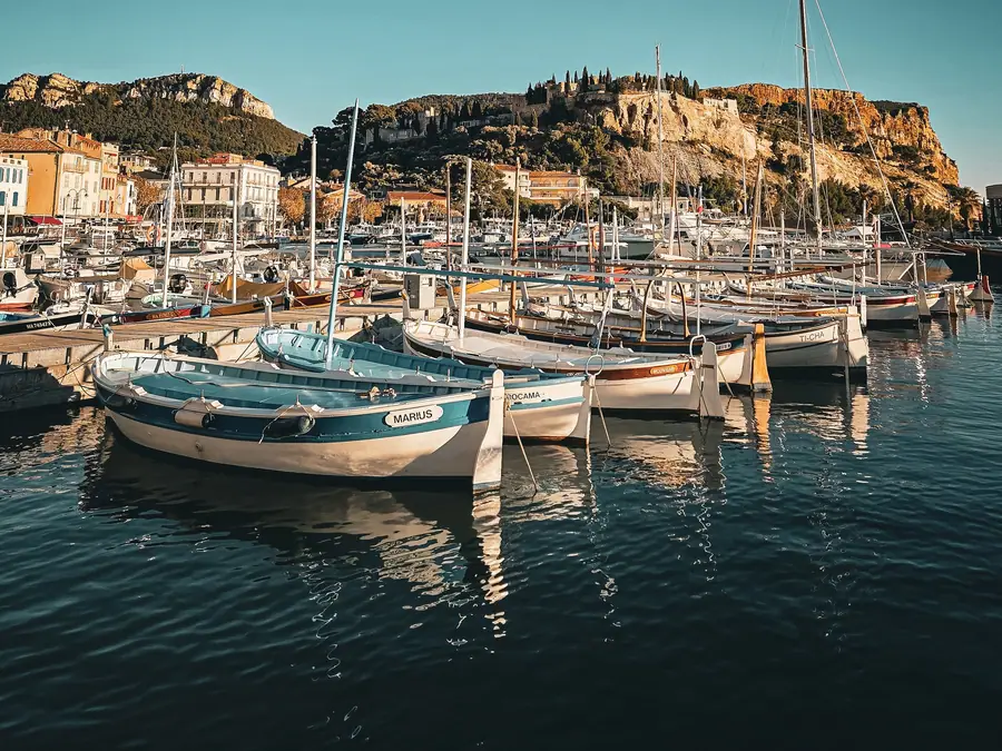 Pointus amarrés au port de Cassis, le château et la falaise du cap Canaille au fond